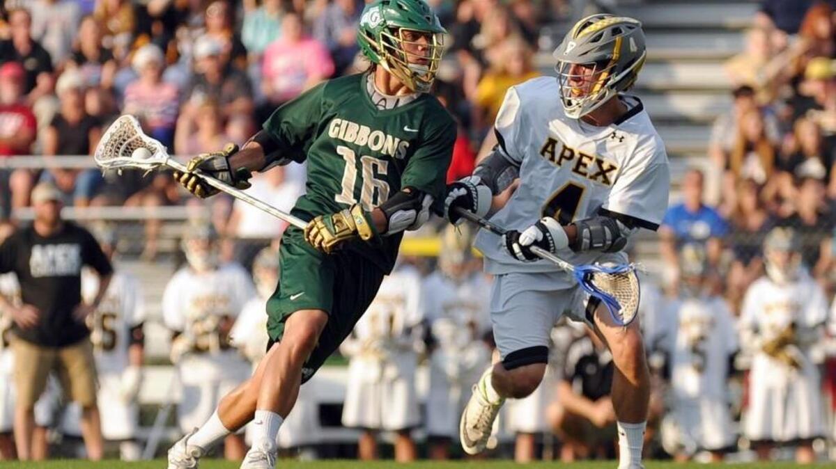 Cardinal Gibbons' Jack Shelton (16) and Apex's Anthony Greco battle during the boys lacrosse game, which was played in Apex on Tuesday, May 10, 2016. Cardinal Gibbons won 8-6.