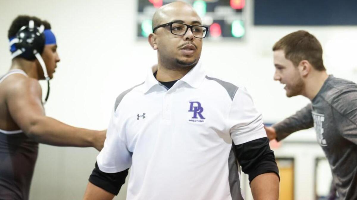 Coach Brandon Palmer looks back during Riverside's playoff wrestling match against Holly Springs at Clayton on Tuesday, February 2, 2016. Holly Springs won the match 37-35.