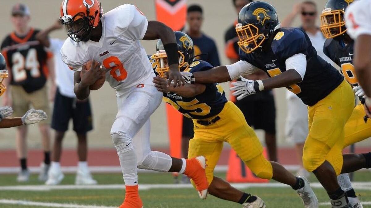 Marvante Beasley (8) of Orange avoids a tackle from Patric Harris, center, and Montrell Webb, right, of Northern to score the first touchdown for the Panthers. The Northern Knights played the Orange Panthers in a football game that took place at the Durham County Memorial Stadium in Durham, N.C. on Friday, August 26, 2016. Orange won 21-13.