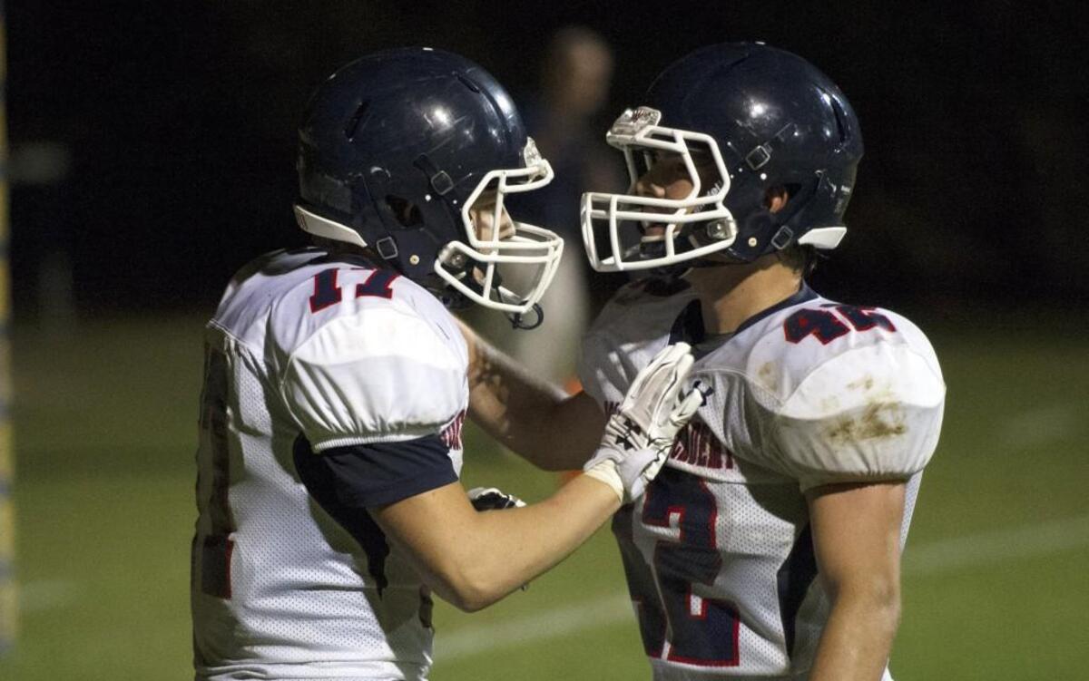 RMA's Jacob Braddy(17) and Thomas Griffin(42) celebrate a touchdown during an NCISAA 8-man matchup between Rocky Mount Academy and St. David's that took place at St. David's High School on October 6, 2016 in Raleigh, North Carolina. Rocky Mount Academy defeats St. David's 60-8.