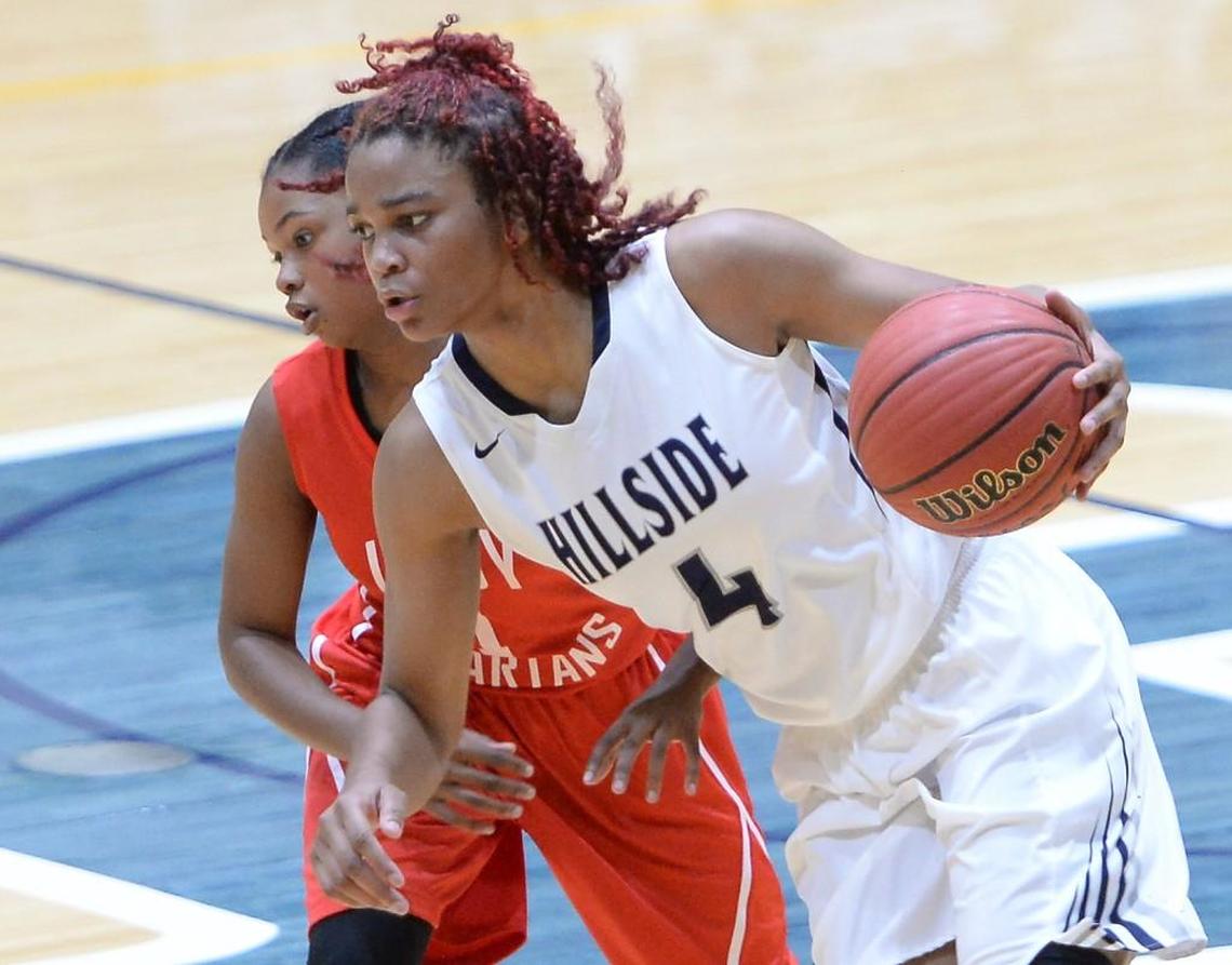 Elisia Grissett (4) of Hillside brings the ball upcourt against Kayla Cadlett, left, of Southern Durham. The Hillside Hornets played the Southern Durham Spartans in a women basketball game that took place in Durham, N.C. on Saturday, December 10, 2016. Hillside won 71-22.