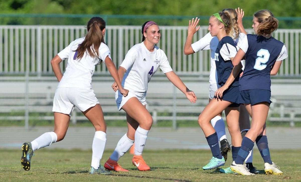 Alexa Wojnovich (4) of Carrboro celebrates along her teammates after scoring the second for the Jaguars. The Carrboro Jaguars played the First Flight Nighthawks in a girls soccer game that took place in Carrboro, N.C. on Tuesday, May 24, 2016. Carrboro won 5-0.