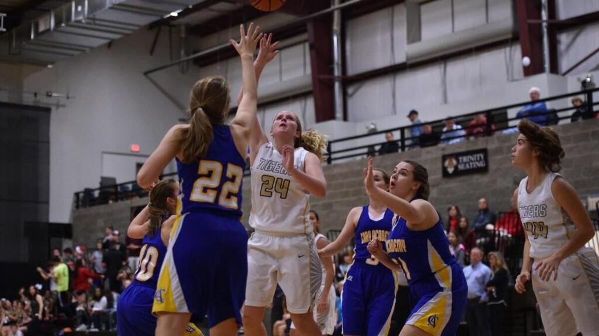 Trinity Academy's Haley Gray (24) shoots the ball as the Cary Academy Chargers took on the Trinity Academy Tigers at Trinity Academy in Raleigh, NC on Tuesday, December 15.