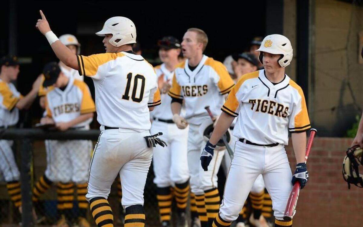 Connor Stough (10) of Chapel Hill celebrates along his teammates after scoring in the first inning of Wednesday’s NCHSAA baseball playoff game against Eastern Guilford. The Chapel Hill Tigers won the game by a 4-3 score.