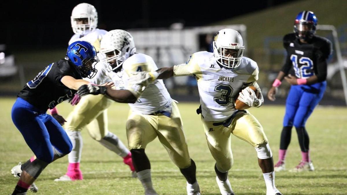 Lee County's Jahmir Smith (3) breaks away from Triton defenders on October 27, 2017.