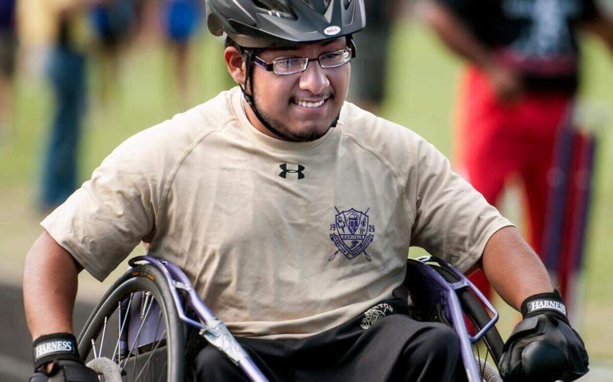 
Broughton's Omar Sanchez rolls across the finish line in the boys 100 meter dash wheel chair during a CAP 8 Championship Track & Field on Saturday, April 18, 2015 in Wake Forest, N.C. Broughton Capitals boys won and Wakefield Wolverines girls won the event.
