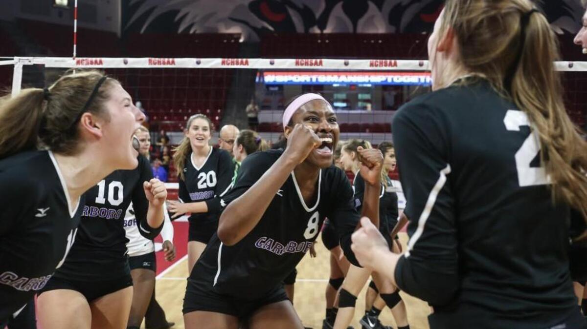 Carrboro's Destiny Cox celebrates the team's championship with her teammates. The Carrboro Jaguars played against the West Iredell Warriors in the high school NCHSAA 2A State Championship volleyball game on Nov. 4, 2017.