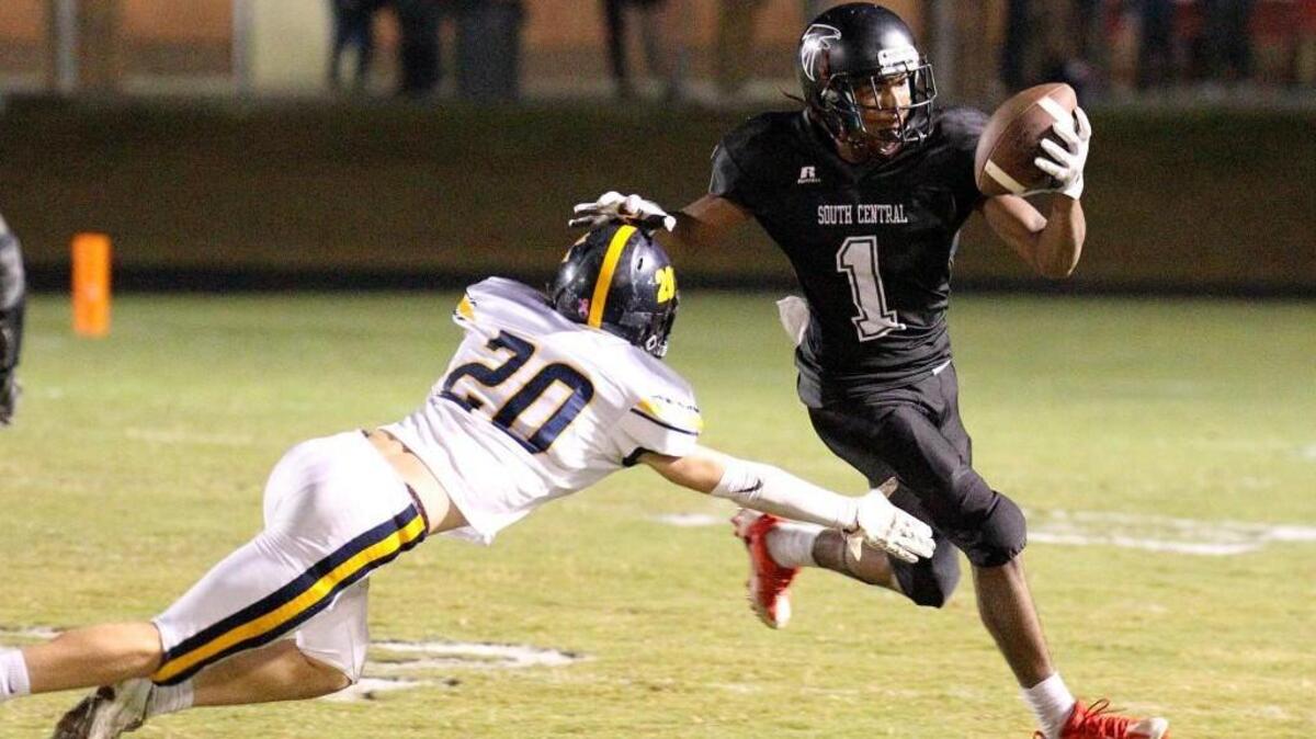 South Central's Emannuel Lewis (1) pushes D.H. Conley's David Lien (20) toward the ground as he runs out of bounds to stop the clock. The D.H. Conley Vikings visited the South Central Falcons in a high school football game on Nov. 3, 2017