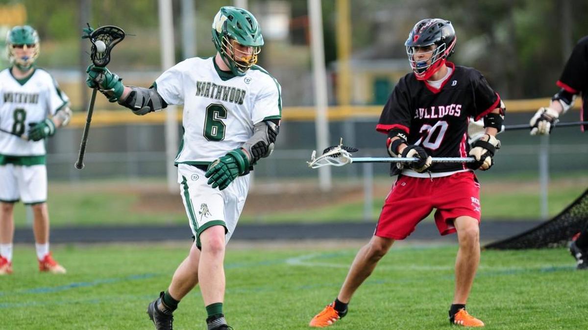 Roxboro Community's Derrick Lubbert (30) challenges Northwood's Nate Little (6) during the boys lacrosse game, which was played in Pittsboro on Friday, April 7, 2017. Northwood won 19-0.