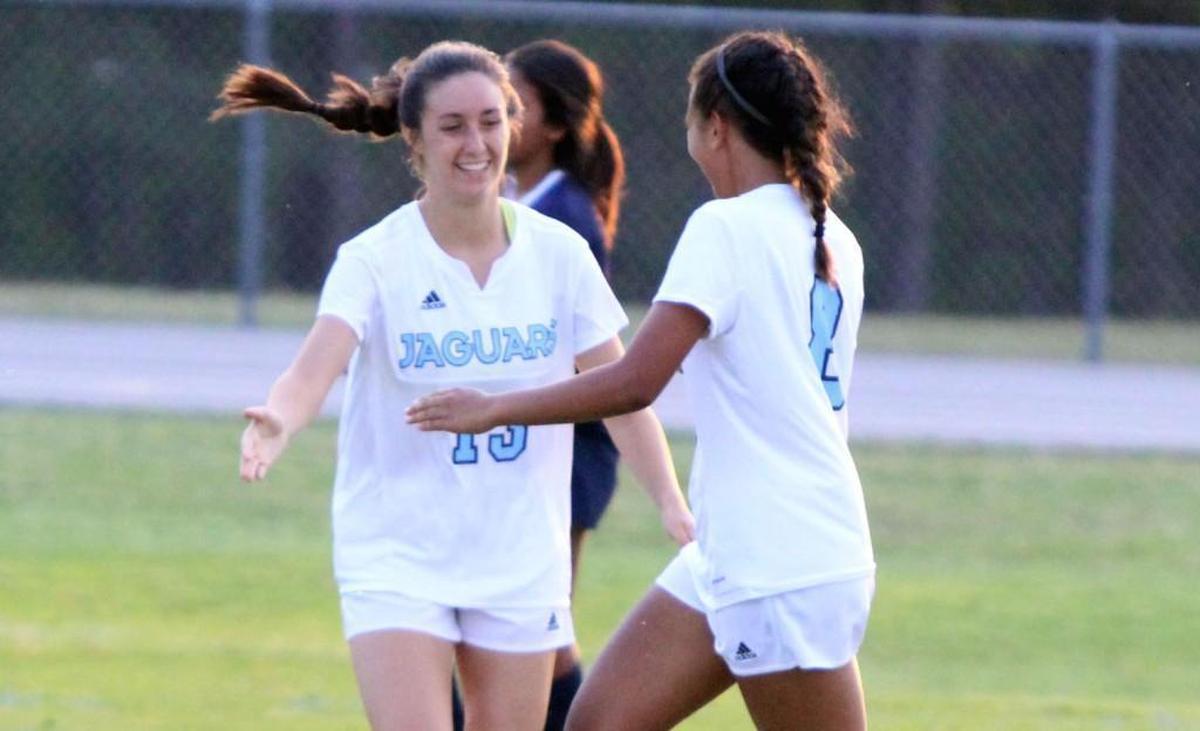 Overhills' Georgia Migos (8) is met by teammate Haleigh Stackpole after scoring during the Lee County at Overhills girls' soccer game in Spring Lake, N.C. on Thursday, April 20, 2017.