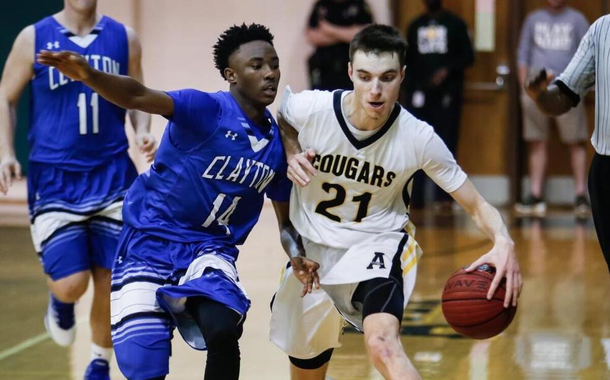 Apex's Eric Fox(21) dribbles upcourt while being pressed by a Clayton defender during Clayton's boys basketball playoff game at Apex on Thursday, February 23, 2017. Apex won the game 83-67.