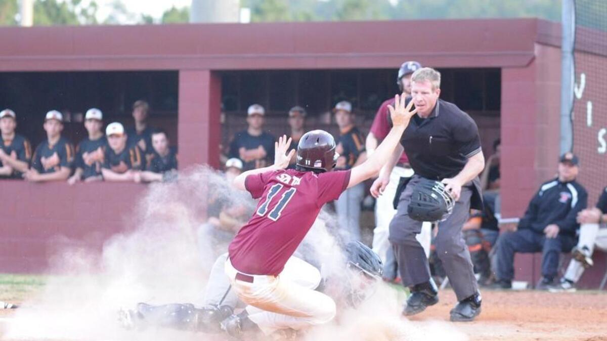 Green Hope's Joel Smith (11) is tagged out at home by Fuquay-Varina's Jake Baize (back) during the baseball game, which was played in Cary on Tuesday, March 8, 2016. Green Hope won 4-1.