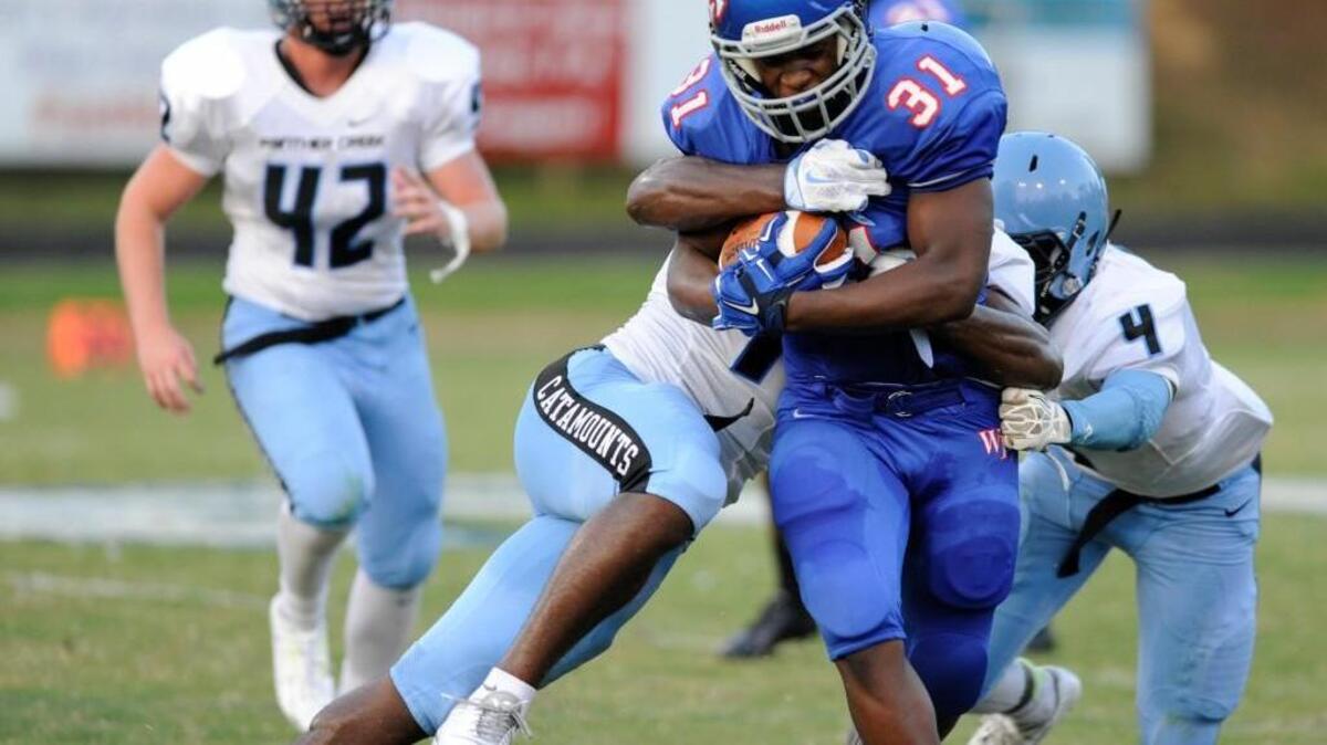 
Wake Forest’s Devon Lawrence (31) is tackled by Panther Creek's Charles Edwards (4) in Wake Forest, N.C. on Friday, August 21, 2015. The Wake Forest Cougars won 48-20.
