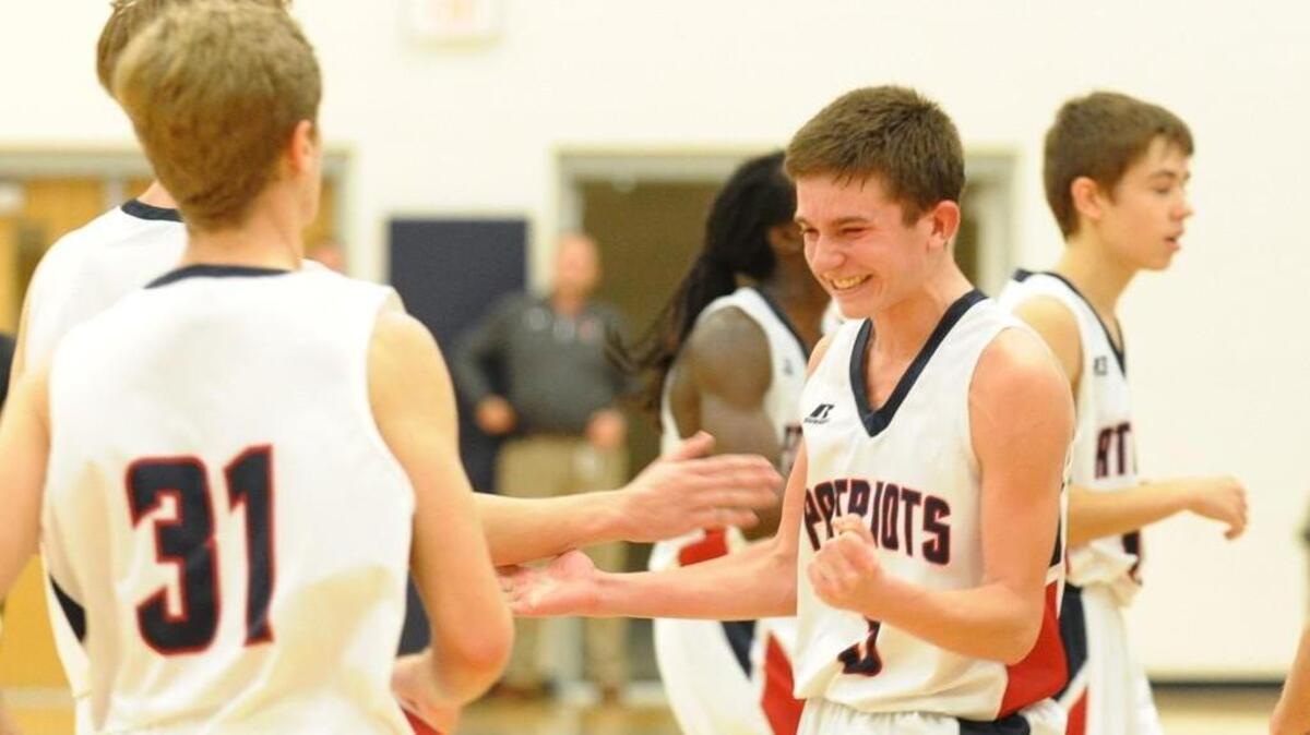 Apex Friendship's Cole Bouquin celebrates their first varsity win during the boys basketball game against Carrboro, which was played in Apex on Wednesday, December 14, 2016. Apex Friendship won 46-43.
