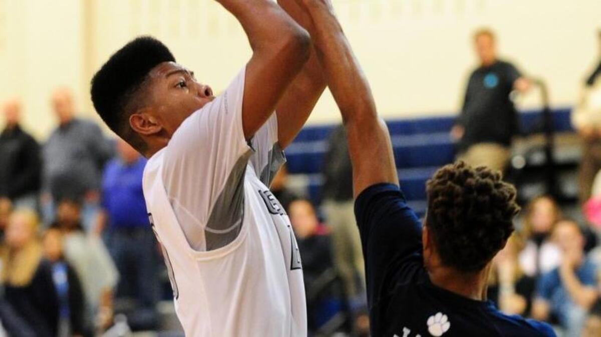 Millbrook’s Trejon Jacob (30) defends a shot by Heritage’s Jayden Garner, right, during the boys basketball game on Friday in Wake Forest. Heritage defeated the previously unbeaten Wildcats, marking the Huskies’ first win over the defending Cap-8 champions in program history.