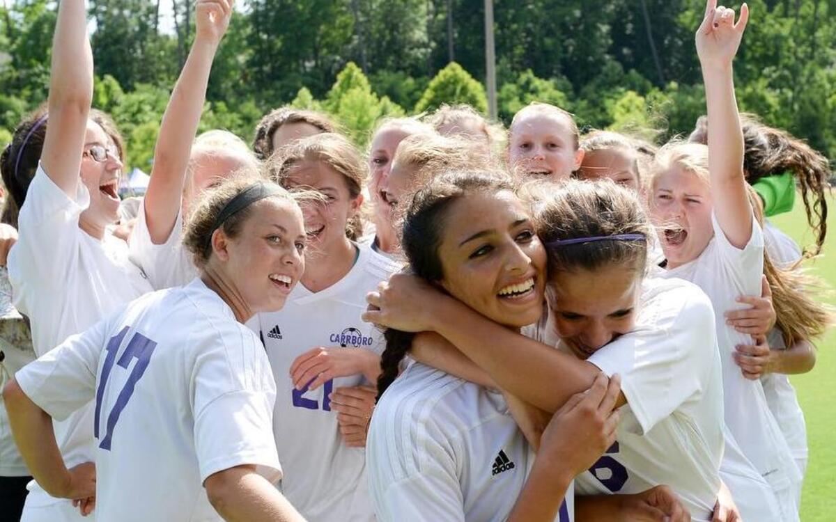 
Carrboro players celebrate their 2-1 overtime victory over Forbush in the NCHSAA 2A women's soccer championship game in Raleigh Saturday, May 29, 2015.

