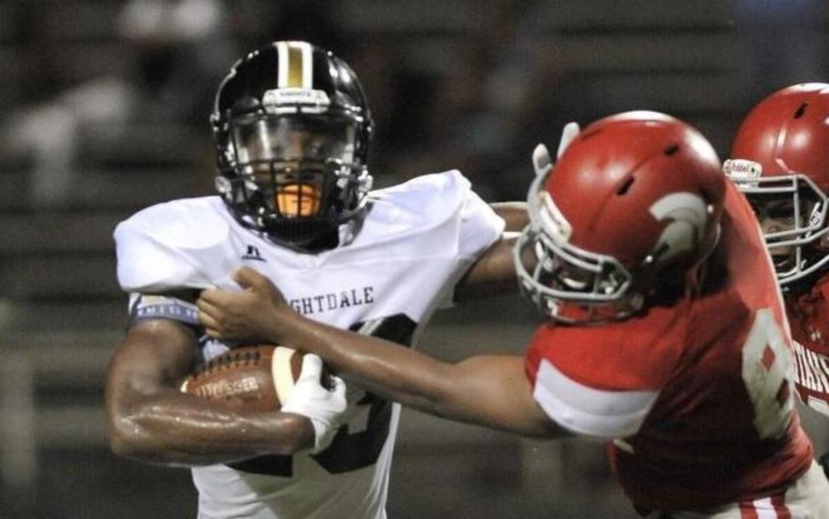 
Knightdale’s Tauraz Williams (23) stiff arms Sanderson's Anthony Brown (84) during Knightdale's Football game against Sanderson. Knightdale won in overtime 35-34. Friday August 21, 2015, Raleigh, N.C.
