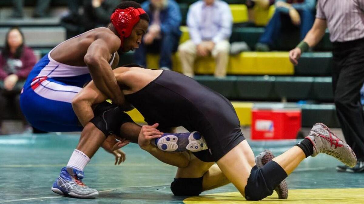 Sanderson's Jimmy Gborrie is taken down by Enloe's Ethan Hoffman as the Sanderson High School Spartans wrestled the Enloe High School Eagles at Enloe High School in Raleigh, NC on Wednesday, January 14.