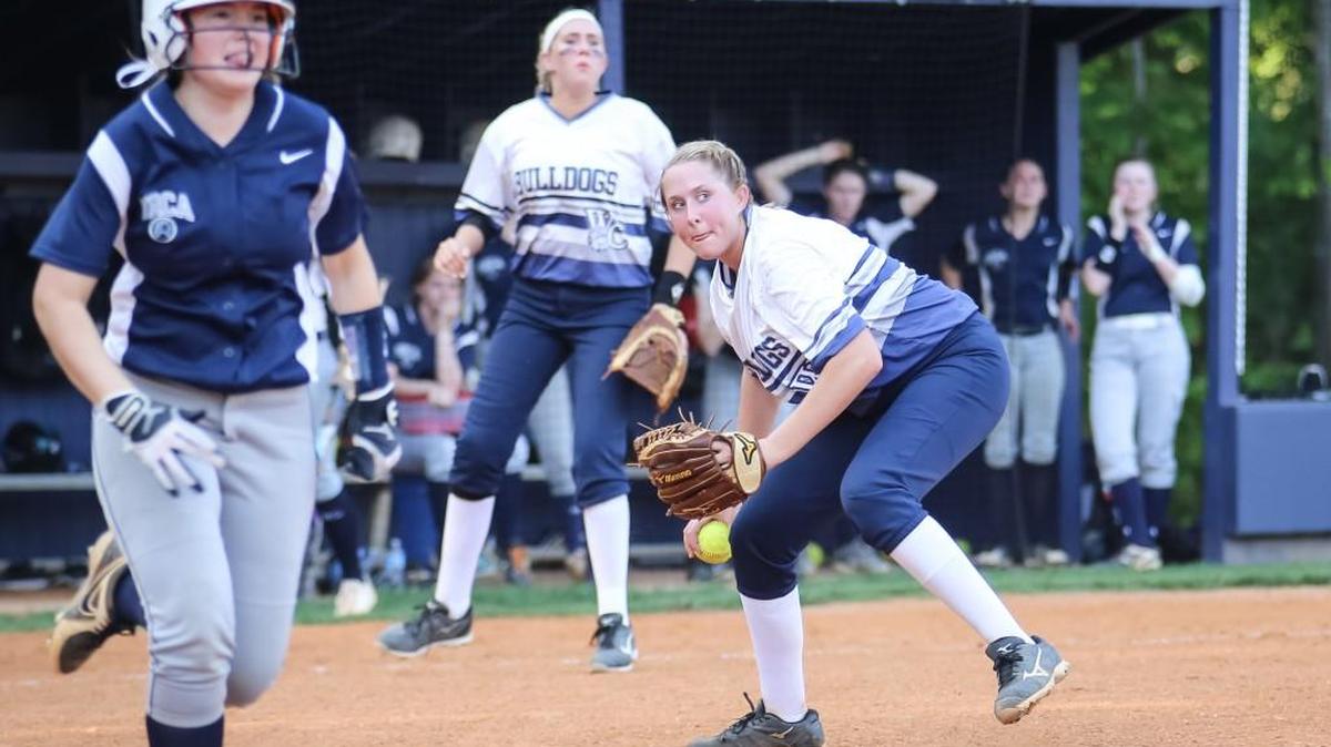 Wake Christian pitcher Marissa Green fields a bunt and throws to first as NRCA's Blakely McKinion, left, runs the bases during NRCA's softball game at Wake Christian on Friday, April 28, 2017. Wake Christian won the game 10-1.
