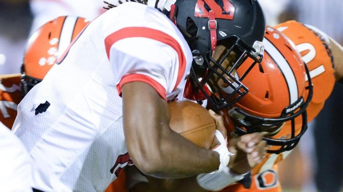 
Jordon Brown, left, of Southern gains yards against a tackle from Bryse Wilson, right, of Orange. The Orange Panthers played the Southern Spartans in Hillsborough, N.C. on Thursday, September 24, 2015. 

