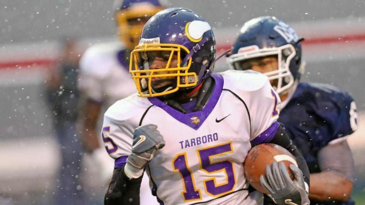 Tarboro's Jyron Albritton (15) runs a blocked punt attempt back to put the Vikings up 12-0 with 7 minutes left in the 2nd quarter. Coverage from the NCHSAA 1AA State Football Championship between the Tarboro Vikings and the Mt. Airy Granite Bears played at Carter-Finley Stadium in Raleigh, N.C. on Saturday, December 9, 2017.