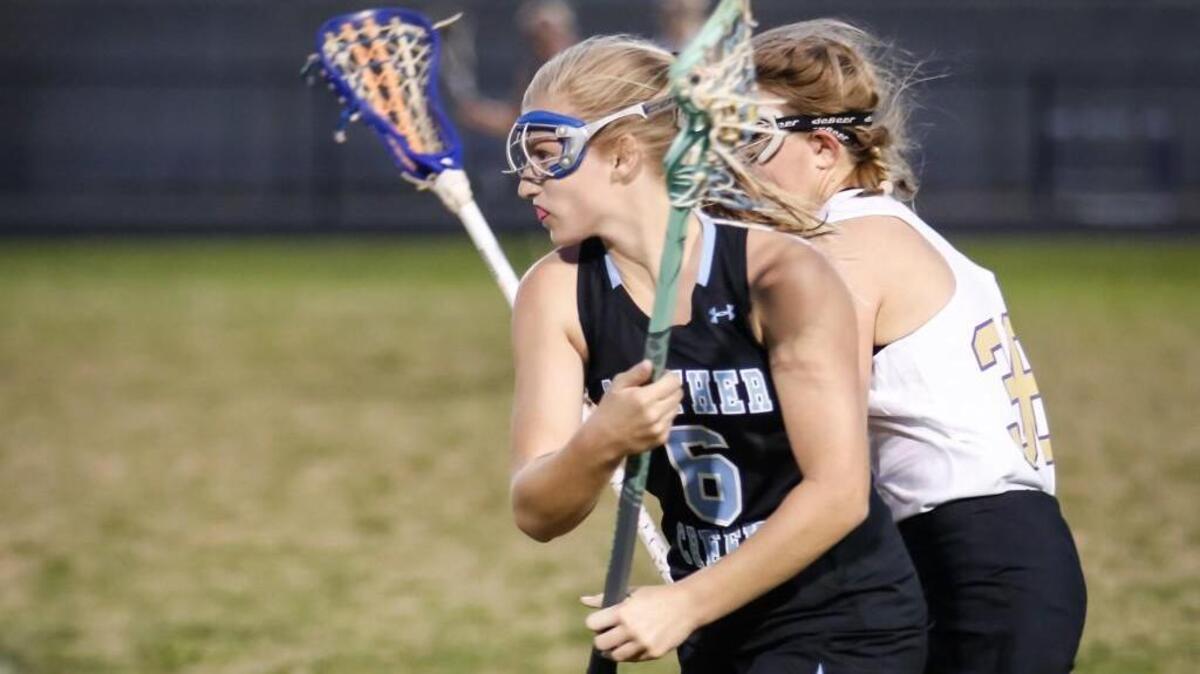 Panther Creek's Megan Collins (6) sprints out of her defensive area with the ball as Holly Springs' Ali Morgan (36) applies pressure during Panther Creek's girls lacrosse match at Holly Springs on Thursday, March 24, 2016. Panther Creek won the game 11-8.