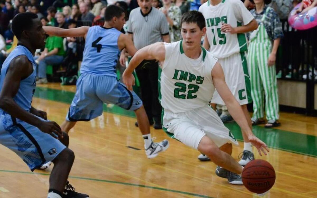 Cory Gensler (22) of Cary dribbles the ball against Justin Smalls, left, of Panther Creek. The Cary Imps played the Panther Creek Catamounts in Cary, N.C. on Tuesday, December 1, 2015. Cary won 67-45.