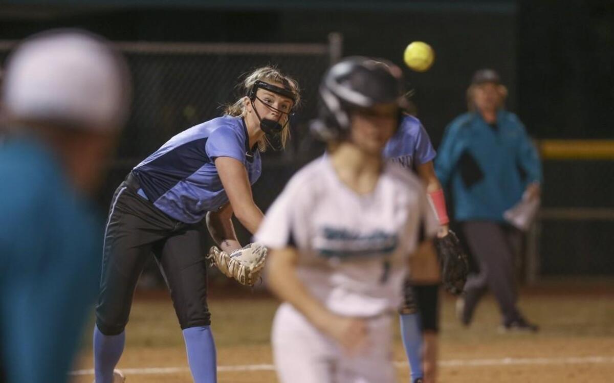 Cleveland pitcher Anna Kate Gilchrist (14) makes the throw to first to put out West Johnston's Rylee Wheeler (1) after she laid down a bunt. Coverage from the prep softball game between the Cleveland High Rams and West Johnston High Wildcats played in Benson, N.C. on Wednesday, March 8, 2017. West Johnston defeated Cleveland 5-0.