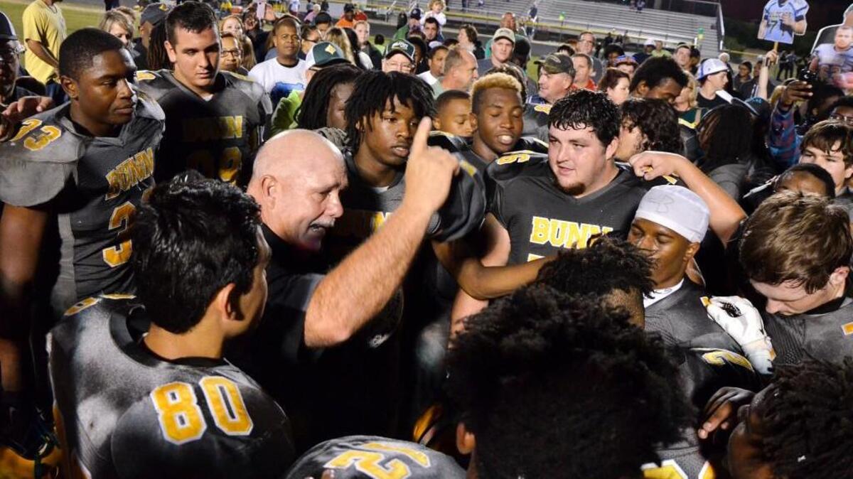 Bunn High School head football coach David Howle (center left), fans and Wildcats players celebrate a 69-32 win over Warren County, a Northern Carolina 2A Conference title and Howle's 200th career victory as Bunn's head football coach in Bunn, N.C. Friday, Nov. 6, 2015.