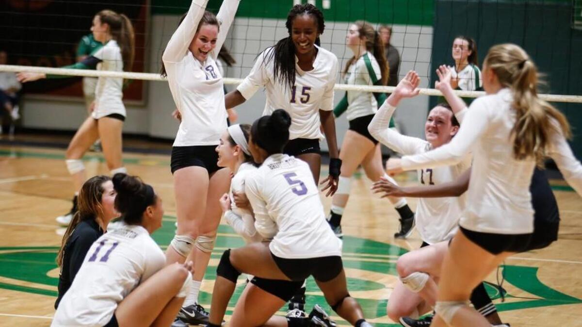 Broughton's team celebrates after scoring the final point during Broughton's volleyball game at Cardinal Gibbons on Saturday, October 29, 2016. Broughton won the game 3-2.
