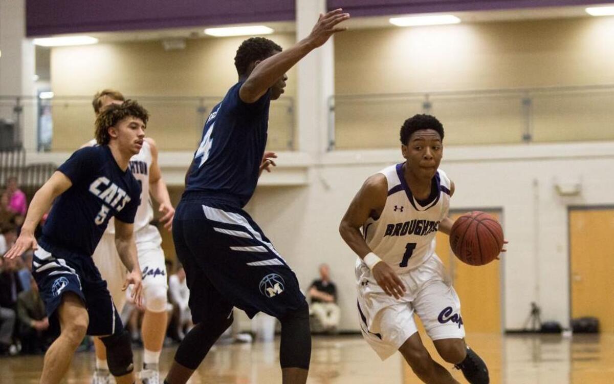 Broughton's Sammy Brock (1) drives as Millbrook's Faison Brock (4) and Jordan Whitfield (5) defend during a high school basketball game in Raleigh, N.C. on Friday, Jan. 29, 2016. Millbrook defeated Broughton 78-57.