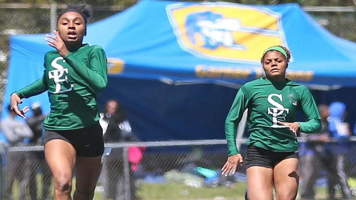 Southeast Raleigh's Kyna Robinson (left) edges out teammate Asya Macon to win the Girls 400 Meter Dash. Coverage from the 2016 Wake County Track and Field Championships held in Garner, N.C. on Saturday, April 9, 2016.