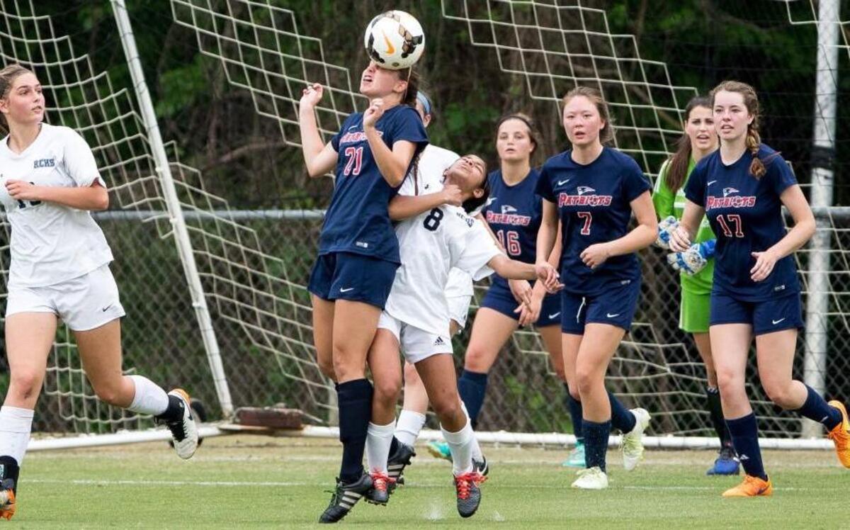 Franklin Academy's Kennedy Capps (21) and Raleigh Charter's Ashley John (8) fight for a ball during a high school soccer game in Cary, N.C. on Friday, Apr. 21, 2017.