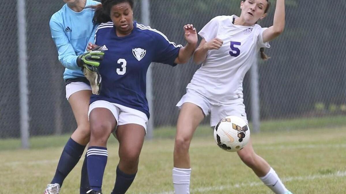 Corinth Holders’ Rosemarie Fitzpatrick (5) battles Wilson Fike’s Mikayla Atkinson (3) and keeper Lexus Caster for control of a shot into the box.