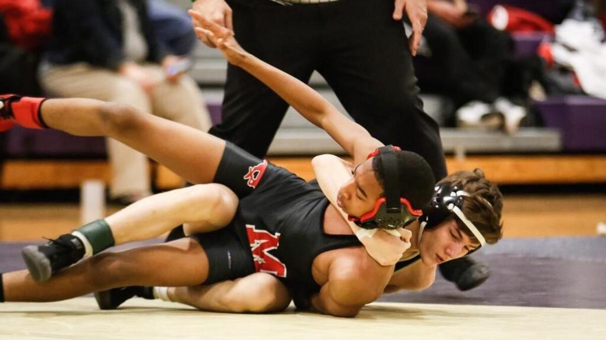 Holly Springs’ Josh Lehr, right, pulls Middle Creek's Branden Lee down to win their 120lb match via pin in 1:04 during Middle Creek's wrestling match at Holly Springs on Wednesday, December 16, 2015. Holly Springs won the match 63-10.
