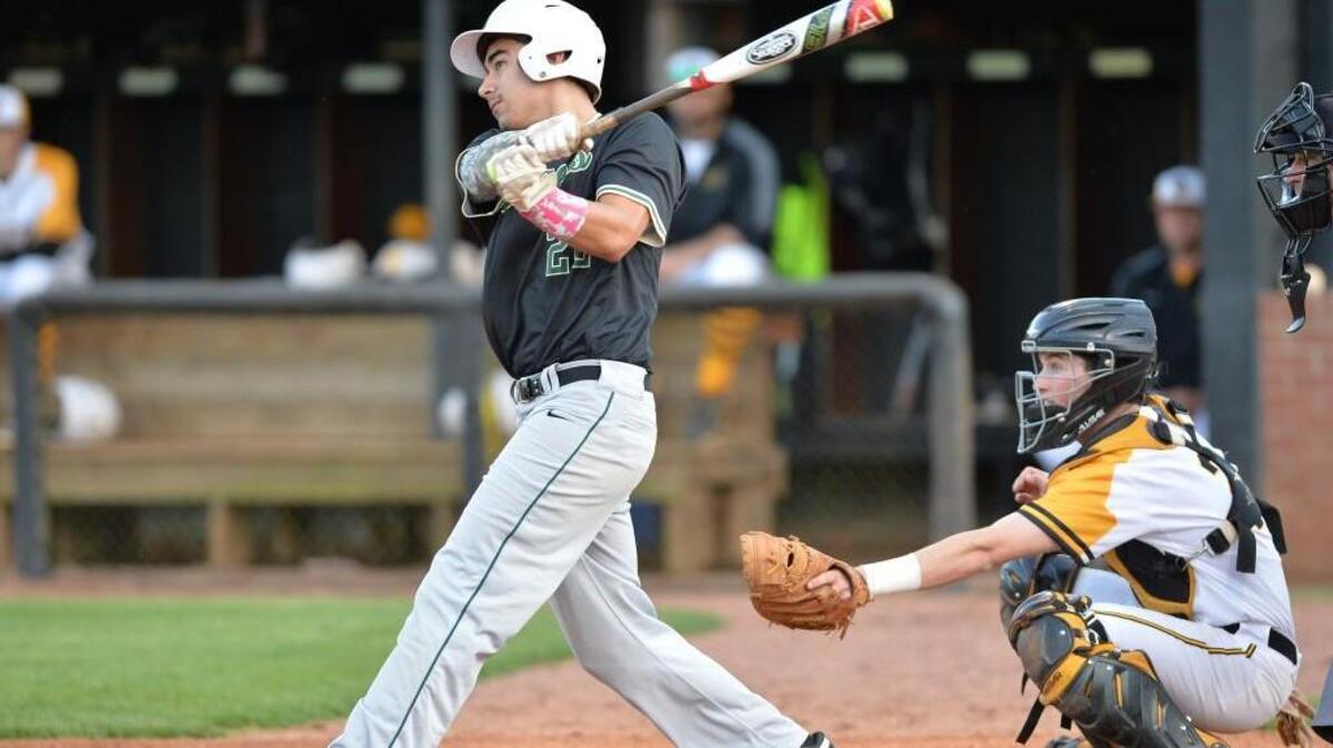 Dylan Mazurek (22) of Northwood swings for the ball in front of Chapel Hill's catcher Garrett Liebe, right. The Chapel Hill Tigers played the Northwood Chargers in a baseball game that took place in Chapel Hill, N.C. on Saturday, May 7, 2016.