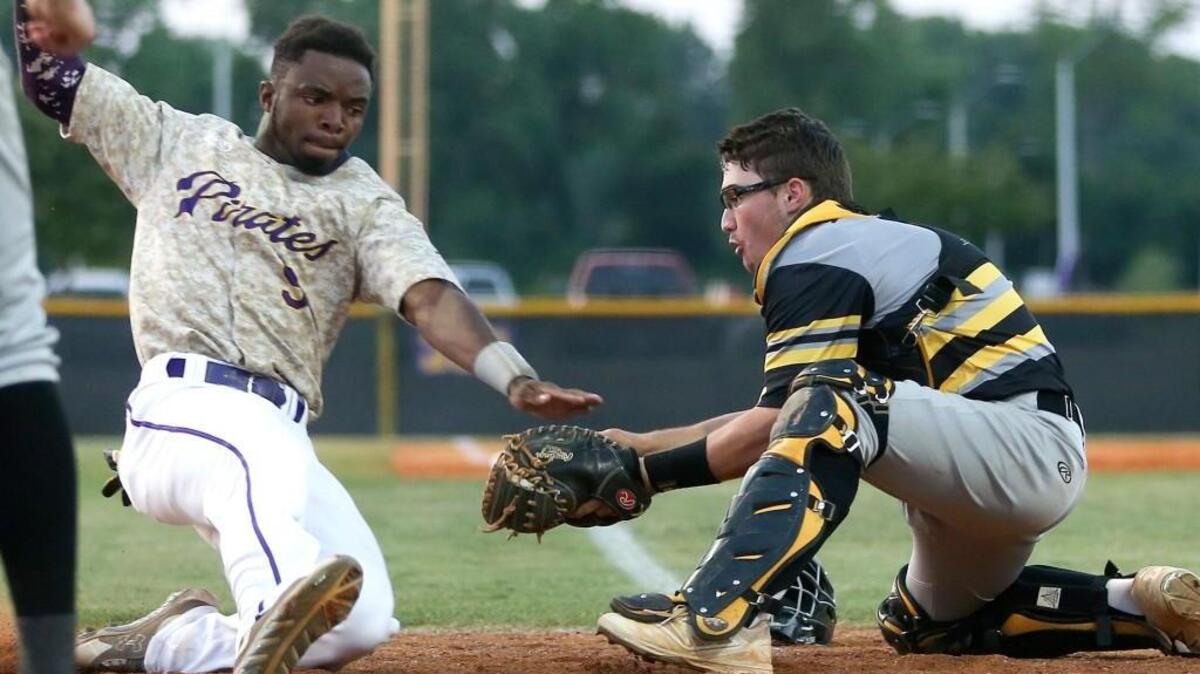 Topsail catcher Colby Emmertz (17) tags out Corinth Holders' Kahlil Hodge (9)in the bottom of the fourth during Corinth Holders’ 2-1 victory in the 3A NCHSAA Eastern Championship baseball series in Archer Lodge, N.C. on Friday, May 27, 2016.