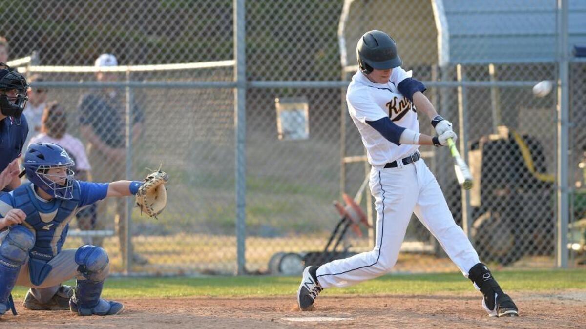 Tyler Mangum, right, of Northern hits the winning ball in front of Person's catcher Mitch Roberts, left, during the 7th inning. The Northern Durham Knights played the Person Rockets in a baseball game that took place in Durham, N.C. on Tuesday, March 21 2017. Northern Durham won 3-2.
