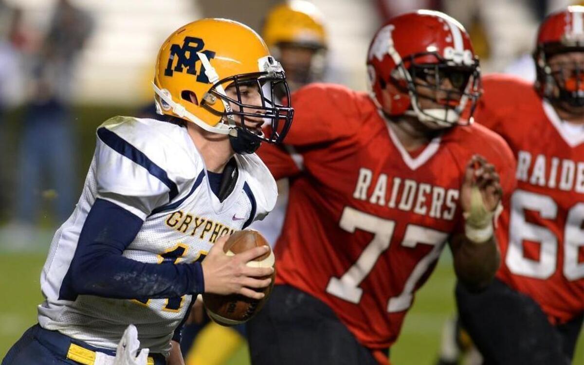 Rocky Mount quarterback Forrest Bell, left, rushes for a 17-yard first down vs South Point during fourth quarter action in the NC 3A Championship game at Kenan Memorial Stadium in Chapel Hill, NC on Friday, December 11, 2015. Rocky Mount defeated South Point 24-21 on a field goal by kicker Chase Miller in overtime.