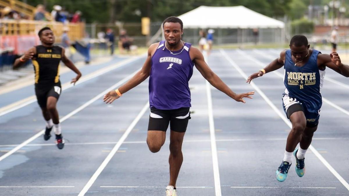 Carrboro's Quinton Adams leans across the finish line to take second place in the 200 meter dash during the NCHSAA 2A and 4A track and field state championships in Greensboro on Friday, May 19, 2017.
