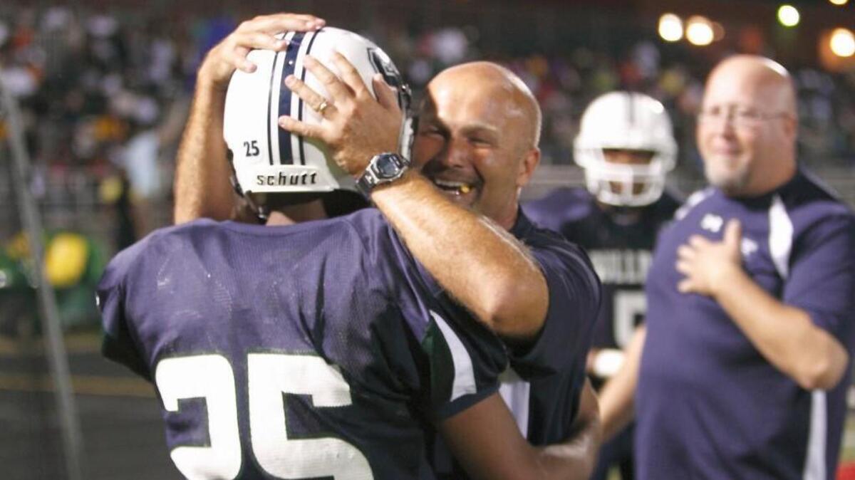 Southeast coach Daniel Finn welcomes Darrius Forrest back to the bench, celebrating the Bulldogs’ win over Knightdale in 2011.