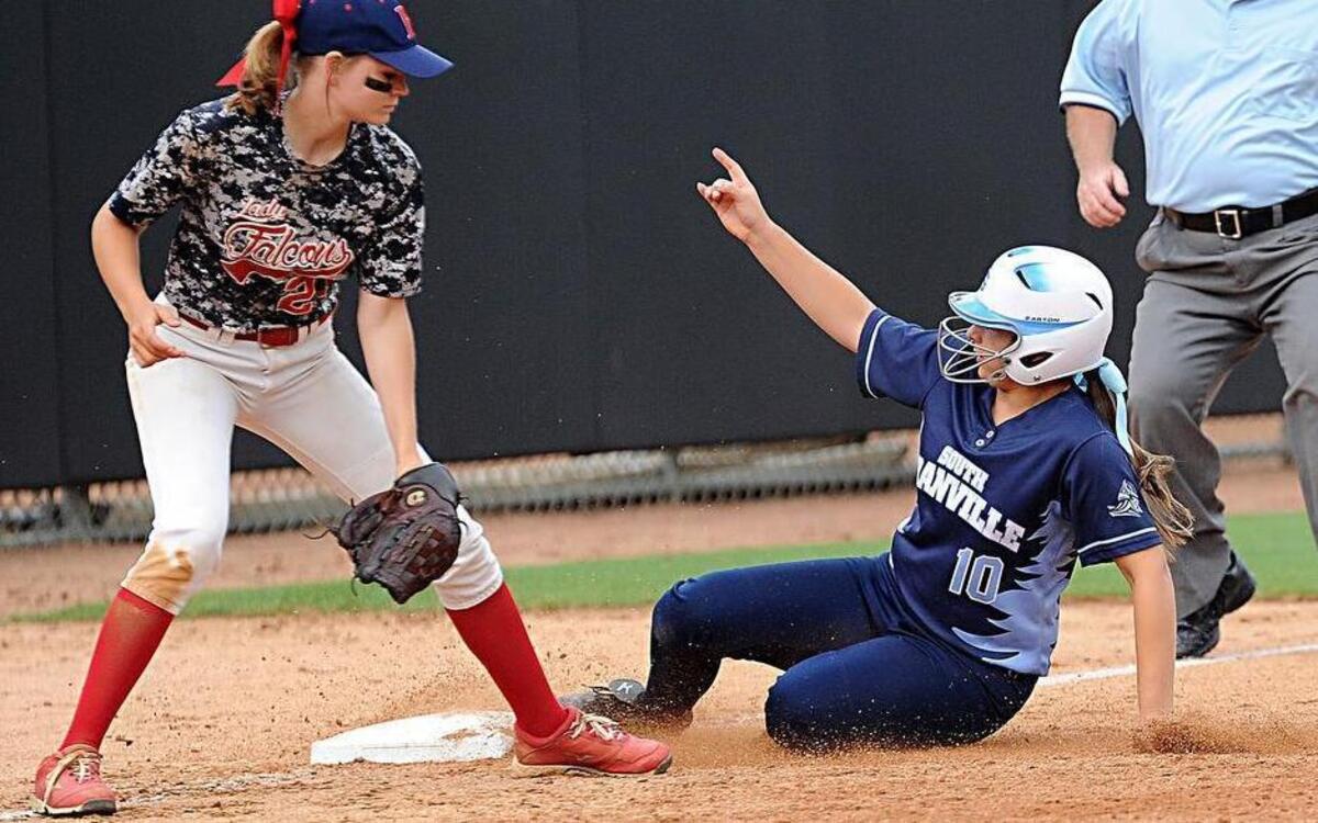 
South Granville's Megan White (10) slides into third base under the tag by Forbush's Allison Mitchell during the NCHSAA 2A girls’ softball championship series at N.C. State’s Dail Stadium on Friday. 
