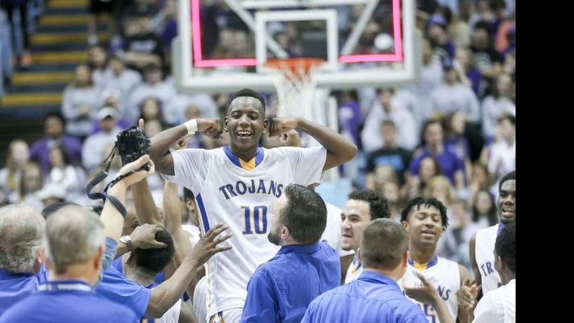 
Garner senior point guard Julius Barnes, the Most Valuable Player of the NCHSAA 4A Boys Basketball State Championship game, celebrates after being lifted off the court by Garner assistant coach Kent Bloms
