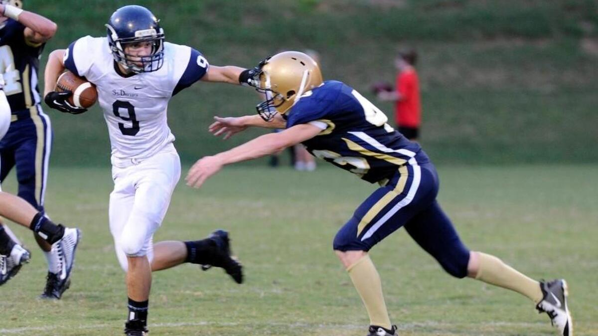 
St. David’s Trey Jeutter (9) stiff arms Cary Christian’s Will Goodall (43) last season. The Warriors open their season Friday. 
