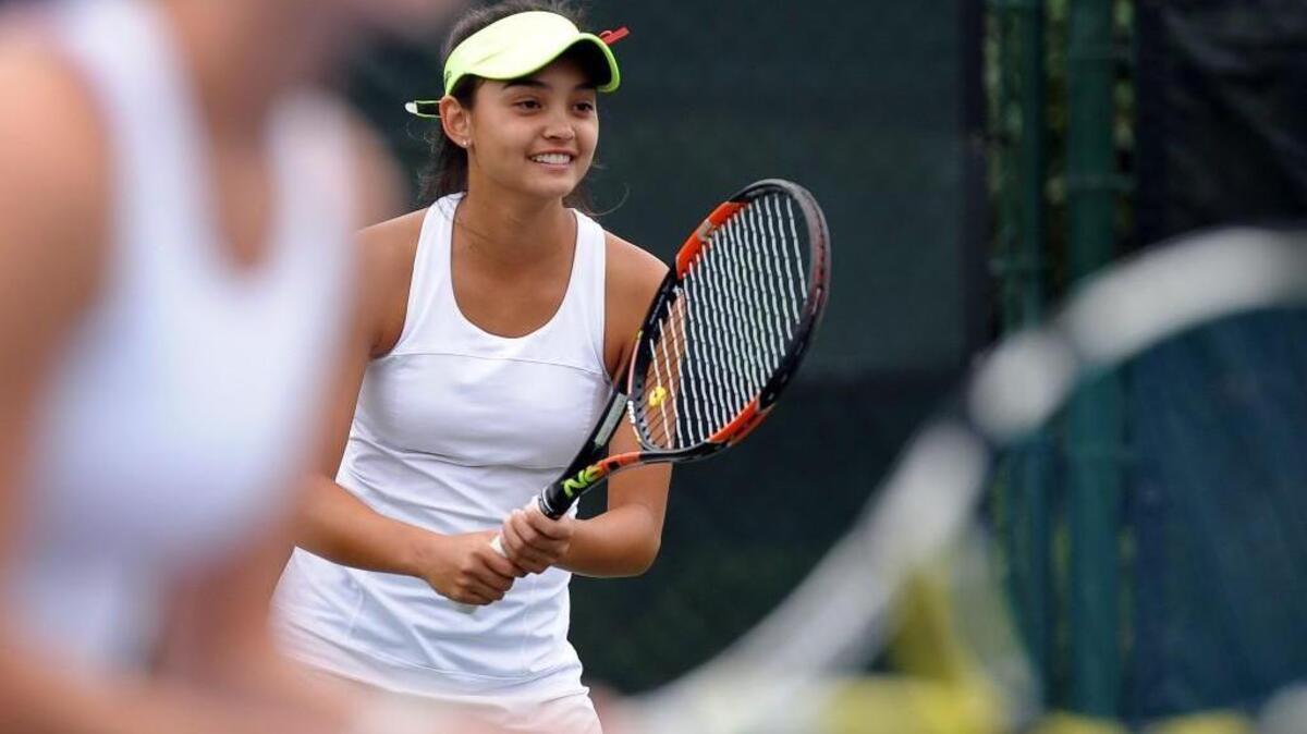 Green Hope's Ana Horvat waits to receive a serve in her doubles tennis match against Panther Creek on September 24, 2015 in Cary.