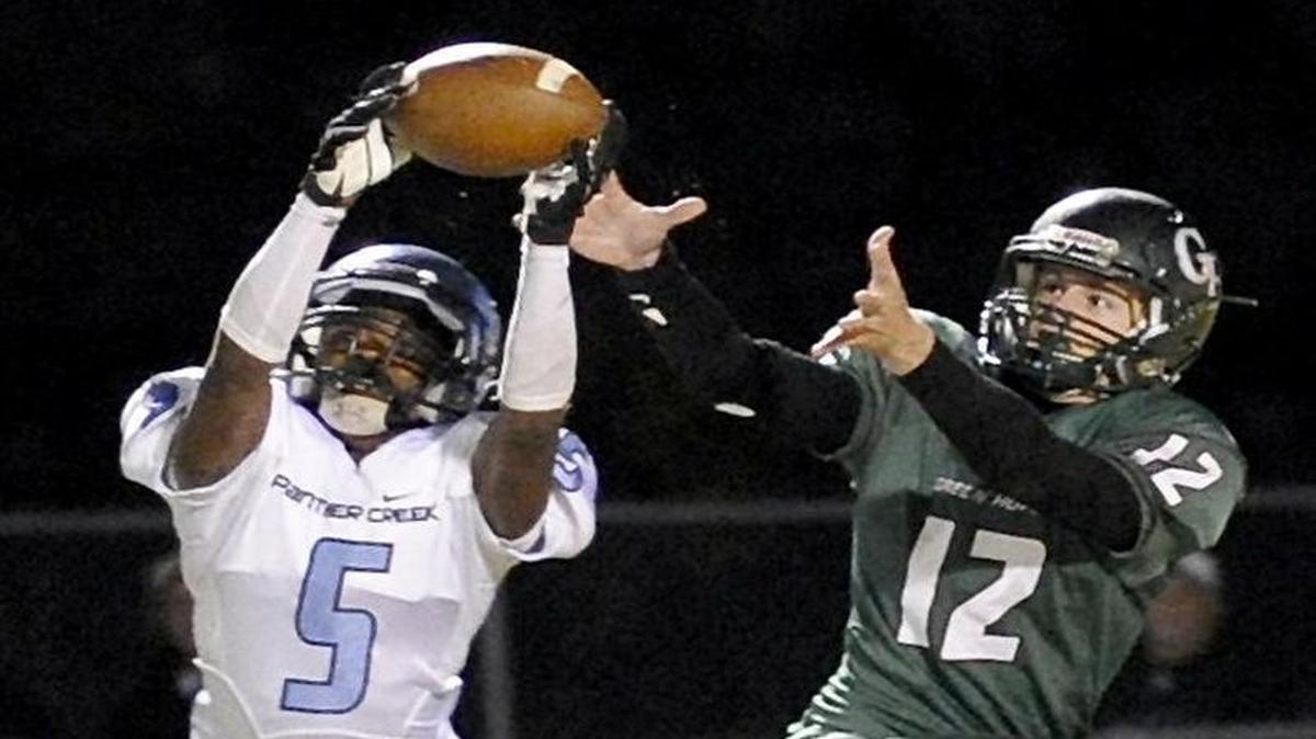
Panther Creek's Quran Moon (5) intercepts a pass intended for Green Hope's Matt Duckworth (12). The Panther Creek Catamounts and the Green Hope Falcons played for the Southwest Wake Athletic Conference title in the last regular season football game in Cary on Friday, November 7, 2014. Green Hope won 17-10.
