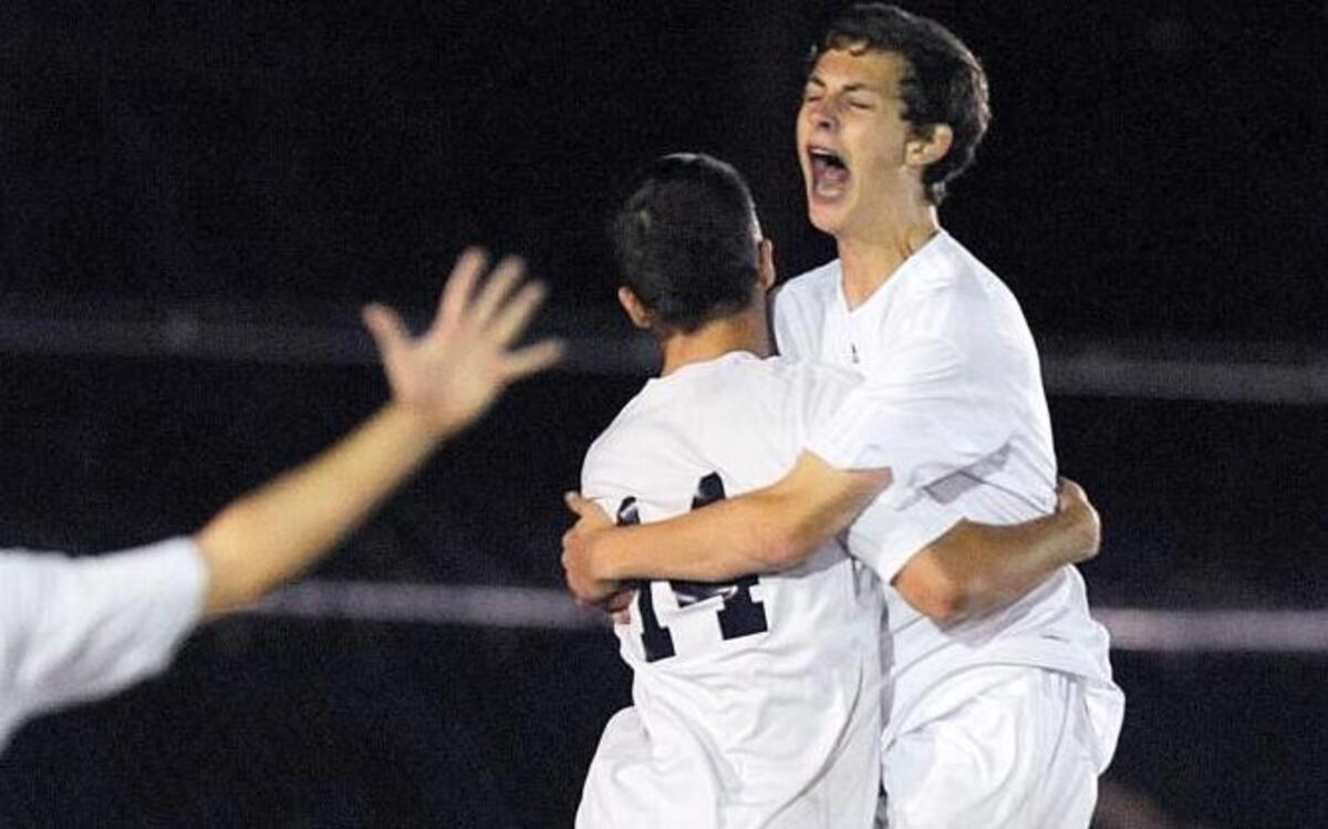Franklin Academy's Jacob Faulkner (4) Chase Moseley (14) and Christian Fitzgerald (23) celebrate their win over Wallace-Rose Hill in their 1A soccer final in Wake Forest, N.C. on Tuesday, November 17, 2015. Franklin Academy won 1-0 to become regional champions.