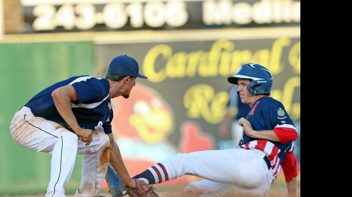 
Raleigh shortstop Dillon Cooper (10) puts the tag on Garner's Cole Hinnant (11) as he tries to take second. Raleigh Post 1 defeated Garner 5-4 in American Legion Baseball played at Fleming Stadium in Wilson N.C. on Sunday, June 14, 2015.
