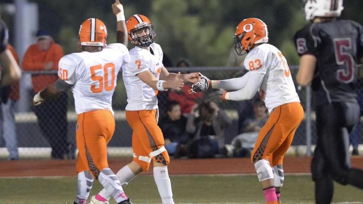 Cody Evans (7) of Orange celebrates a touchdown along his teammates Taison Farrington (50) and Ryan Sellers (83). The Cedar Ridge Red Wolves played the Orange Panthers in a football game that took place in Hillsborough, N.C. on Friday, October 14, 2016. Orange won 42-3.
