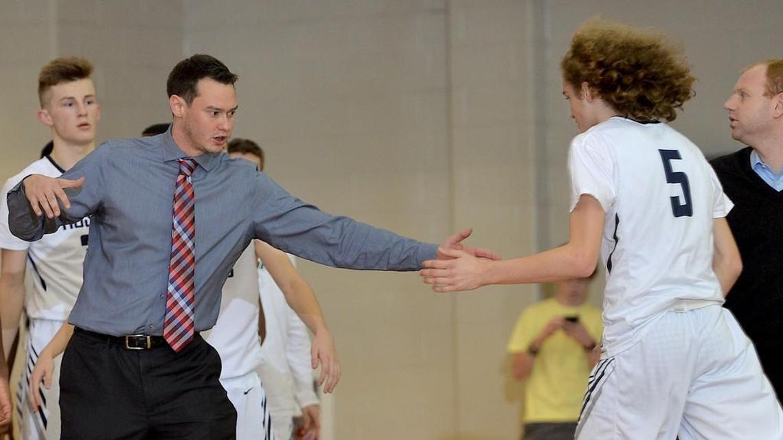 Heritage HIgh School head basketball coach Tilden Brill III congratulates Redford Dunton (5) during a timeout. The Wake County school system might put on hold $1.4 million in extra-duty pay raises to help close a $25.5 million budget gap.